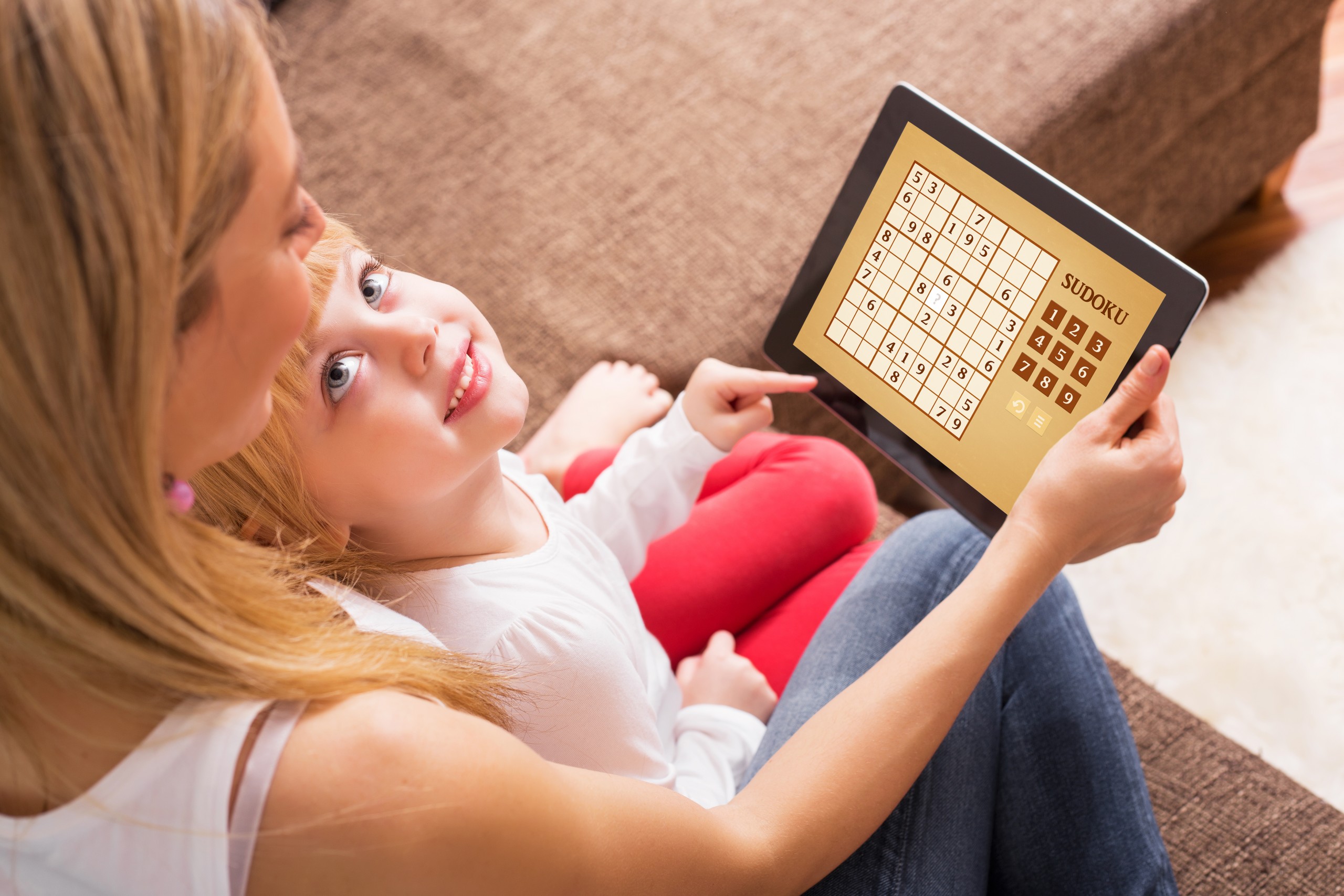 <p>Mother and child playing Sudoku together</p>
